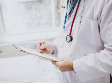 Physician noting down symptoms of a patient
