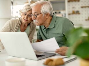 Senior couple analyzing their savings while going through home f